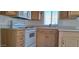 Bright kitchen features wooden cabinets, white appliances, and a functional layout for meal preparation at 17200 W Bell Rd # 1501, Surprise, AZ 85374