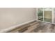Bedroom with wood-style flooring and natural light from sliding glass door to patio at 17228 N 16Th Dr # 3, Phoenix, AZ 85023