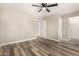 Bedroom with wood-style flooring, a ceiling fan, and two doorways at 17228 N 16Th Dr # 3, Phoenix, AZ 85023
