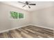 Bright bedroom featuring a ceiling fan and a large window with a lush, green view at 17228 N 16Th Dr # 3, Phoenix, AZ 85023