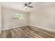 Bedroom with wood-style flooring, a ceiling fan, and a window bringing in natural light at 17228 N 16Th Dr # 3, Phoenix, AZ 85023