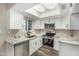 Updated kitchen featuring white cabinetry, stainless steel appliances, and marble countertops at 17228 N 16Th Dr # 3, Phoenix, AZ 85023