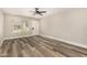 Bright open concept living room with modern ceiling fan and wood-look flooring at 17228 N 16Th Dr # 3, Phoenix, AZ 85023