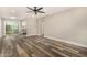 Spacious living room with a ceiling fan, modern wood floors and a view of the kitchen at 17228 N 16Th Dr # 3, Phoenix, AZ 85023