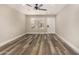 Bright open concept living room with modern ceiling fan and wood-look flooring at 17228 N 16Th Dr # 3, Phoenix, AZ 85023