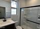 Bathroom featuring a glass-enclosed shower, single vanity with a sink, and modern fixtures at 17535 W Fulton St, Goodyear, AZ 85338