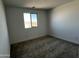 Cozy bedroom featuring plush carpet and a window offering outdoor views at 17535 W Fulton St, Goodyear, AZ 85338