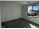 Bright bedroom with plush carpet and a large window offering neighborhood views at 17535 W Fulton St, Goodyear, AZ 85338
