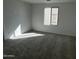 Carpeted bedroom with white walls and a window allowing natural light to flood the room at 17535 W Fulton St, Goodyear, AZ 85338
