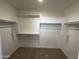 Walk-in closet featuring wooden rods and shelving, offering ample storage space at 17535 W Fulton St, Goodyear, AZ 85338