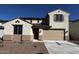 Two-story home featuring a two-car garage, stucco siding, and a tile roof, under a bright blue sky at 17535 W Fulton St, Goodyear, AZ 85338