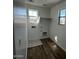 Functional laundry room features wood flooring and plenty of natural light at 17535 W Fulton St, Goodyear, AZ 85338