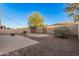 Serene backyard featuring lush landscaping, brick-paved patio, and a cozy fire pit area, creating an inviting outdoor retreat at 1783 W Cool Water Way, San Tan Valley, AZ 85144
