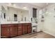 A double vanity in a bathroom featuring tile floors and a vanity with ample lighting and a walk in shower at 1783 W Cool Water Way, San Tan Valley, AZ 85144