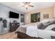 Comfortable bedroom featuring a ceiling fan, dark wood furniture, and stylish decor, creating a relaxing atmosphere at 1783 W Cool Water Way, San Tan Valley, AZ 85144