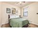 A bedroom with ample light and a ceiling fan provides a soothing ambiance with a neutral palette at 1783 W Cool Water Way, San Tan Valley, AZ 85144