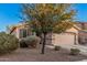 Charming single-story home featuring neutral stucco, a three-car garage and a manicured front yard at 1783 W Cool Water Way, San Tan Valley, AZ 85144
