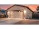 Close up view of the two-car garage showing number, brick lined driveway, and side yard at 1783 W Cool Water Way, San Tan Valley, AZ 85144