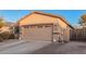 Home features a two-car garage with brick detail on the driveway and solar panels on the roof at 1783 W Cool Water Way, San Tan Valley, AZ 85144