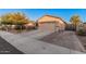 This home boasts a wide driveway and two-car garage, with solar panels visible in the background at 1783 W Cool Water Way, San Tan Valley, AZ 85144
