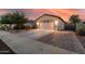 This home boasts a wide driveway and two-car garage, with solar panels visible in the background at 1783 W Cool Water Way, San Tan Valley, AZ 85144
