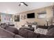 Spacious living room with large sectional, modern decor, and lots of natural light at 1783 W Cool Water Way, San Tan Valley, AZ 85144