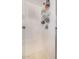 A shower with tiled walls and modern fixtures, a shower caddy, with a clear glass door is well lit at 1783 W Cool Water Way, San Tan Valley, AZ 85144
