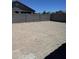 Large, private back yard is ready for landscaping with block wall and blue sky at 18340 W Patrick Ln, Surprise, AZ 85387