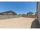 The large, level backyard is enclosed with a block wall, providing privacy and security at 18340 W Patrick Ln, Surprise, AZ 85387