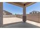 A covered patio overlooks a spacious backyard with block wall and desert landscaping at 18340 W Patrick Ln, Surprise, AZ 85387