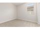 Standard bedroom with plush carpeting and natural light from a window at 18340 W Patrick Ln, Surprise, AZ 85387