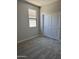 Empty bedroom features neutral walls, new carpet, a closet, and natural light from a window at 18340 W Patrick Ln, Surprise, AZ 85387