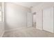 A bright bedroom with neutral walls and carpet. Includes a closet and adjoining bathroom at 18340 W Patrick Ln, Surprise, AZ 85387