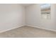 Standard bedroom with plush carpeting and natural light from a window at 18340 W Patrick Ln, Surprise, AZ 85387