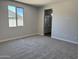 Empty bedroom features neutral walls, new carpet, and natural light from a window at 18340 W Patrick Ln, Surprise, AZ 85387