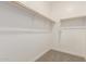 Walk-in closet with dual clothing rods and plush carpeting at 18340 W Patrick Ln, Surprise, AZ 85387
