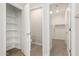 Open view of walk-in closets including shelving, a commode, and carpeted area at 18340 W Patrick Ln, Surprise, AZ 85387