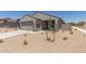New single-story home with a two-car garage, desert landscaping, and concrete driveway on a sunny day at 18340 W Patrick Ln, Surprise, AZ 85387
