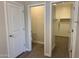 Hallway leading to a half bathroom and a walk-in closet space at 18340 W Patrick Ln, Surprise, AZ 85387