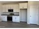 Modern kitchen featuring white cabinets, stainless steel appliances, and lots of storage space at 18340 W Patrick Ln, Surprise, AZ 85387
