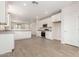 Bright kitchen with white cabinets, stainless steel appliances, gray countertops, and wood-look tile flooring at 18340 W Patrick Ln, Surprise, AZ 85387
