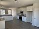 Bright, open kitchen featuring white cabinets, stainless steel appliances, and expansive countertops at 18340 W Patrick Ln, Surprise, AZ 85387