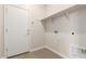 A dedicated laundry room with washer and dryer hookups and storage shelving at 18340 W Patrick Ln, Surprise, AZ 85387