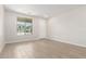Bright living room with wood-look tile, natural light, and neutral walls at 18340 W Patrick Ln, Surprise, AZ 85387