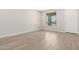 Bright living room with wood-look tile, natural light, and neutral walls at 18340 W Patrick Ln, Surprise, AZ 85387