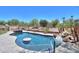 Sparkling pool with built-in bar and lush landscaping creates a serene outdoor retreat at 19969 N Santa Cruz Dr, Maricopa, AZ 85138