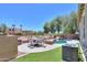 Private backyard with a pool, lush landscaping, and an outdoor dining area, creating an ideal retreat at 19969 N Santa Cruz Dr, Maricopa, AZ 85138