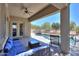Covered patio seating overlooking a sparkling pool with a built-in bar, perfect for entertaining at 19969 N Santa Cruz Dr, Maricopa, AZ 85138