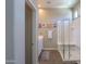 Spa-like bathroom featuring wood-look tile, glass enclosed shower and decorative tile accents at 19969 N Santa Cruz Dr, Maricopa, AZ 85138