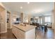 Open floor plan of kitchen features a spacious center island and flows into the dining and living areas at 19969 N Santa Cruz Dr, Maricopa, AZ 85138